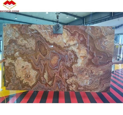 Marbre en onyx rouge tigre naturel polissé translucide pour le design d'hôtel en jade moderne rétroéclairé